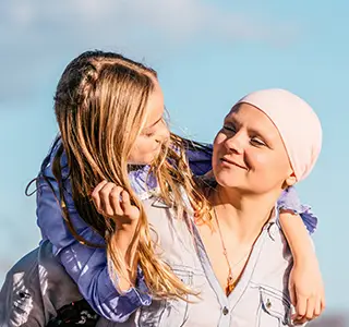 Two people embracing, representing support and care.